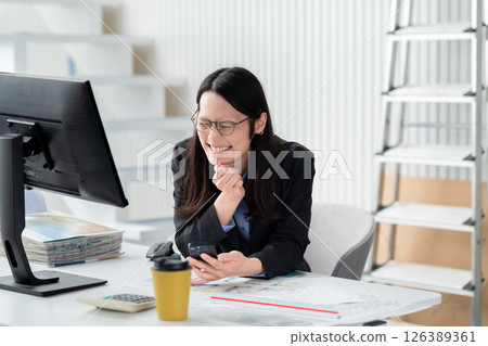 A construction company employee with a smartphone looking troubled 126389361