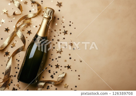 Champagne bottle with golden ribbon and star confetti on a textured beige background Champagne bottle with golden ribbon and star confetti on a textured beige background 126389708