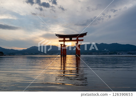 Famous red torii gate of Itsukushima shrine at sunset in Miyajima, Japan Famous red torii gate of Itsukushima shrine at sunset in Miyajima, Japan 126390653