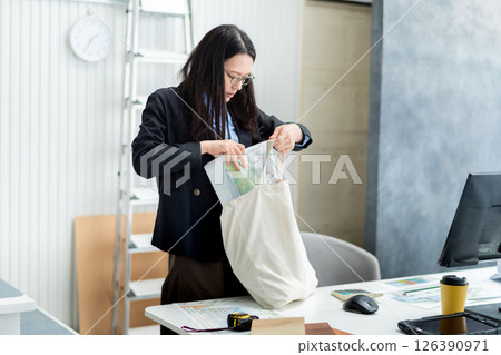 A female employee of a construction company preparing to depart A female employee of a construction company preparing to depart 126390971