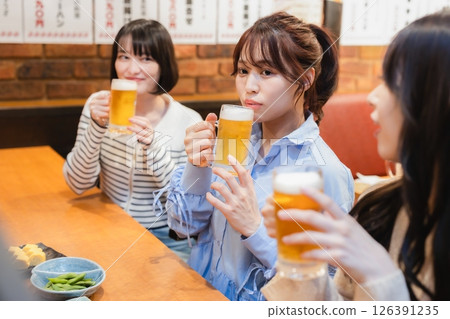 Woman drinking beer Woman drinking beer 126391235