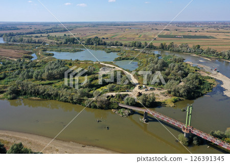 Aerial view of gravel pit mining reservoir and river, ballast, ecological impact on environment Aerial view of gravel pit mining reservoir and river, ballast, ecological impact on environment 126391345