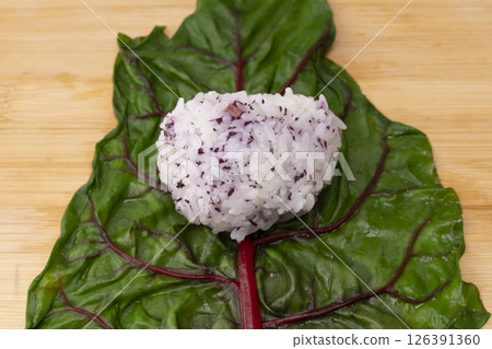 Swiss chard onigiri: The process of making onigiri wrapped in Swiss chard leaves Swiss chard onigiri: The process of making onigiri wrapped in Swiss chard leaves 126391360