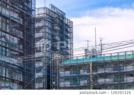 Yokohama cityscape in Japan - View of scaffolding and protective netting set up for repairs and inspections of apartment buildings (Yokohama city) 126391529