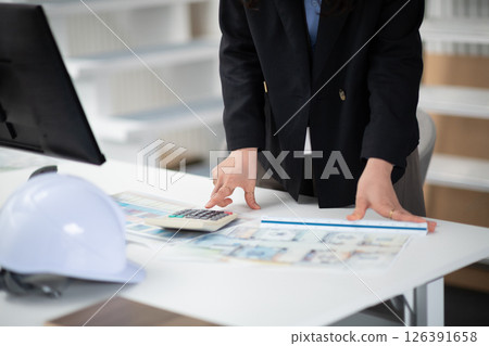 A construction company employee checking a drawing 126391658