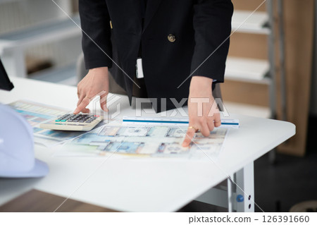 A construction company employee checking a drawing 126391660