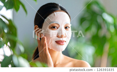 Woman applying face mask (AI generated image) 126391835