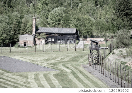 The memorial in Lesetice, Czechia, features a former prison complex surrounded by greenery. The site serves as a reminder of the victims of communism and their suffering. The memorial in Lesetice, Czechia, features a former prison complex surrounded by greenery. The site serves as a reminder of the victims of communism and their suffering. 126391902