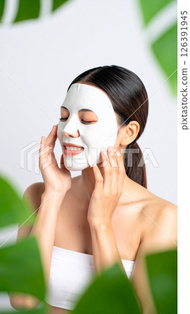 Woman applying face mask (AI generated image) 126391945