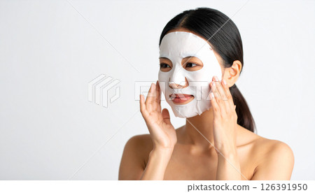 Woman applying face mask (AI generated image) 126391950