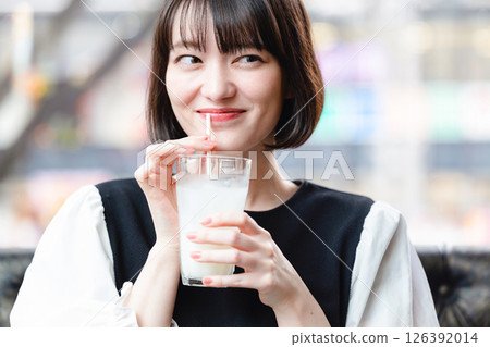 Young woman drinking a soft drink 126392014