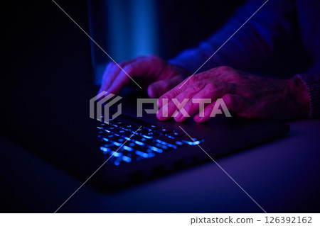 Male hands are typing on a laptop keyboard. 126392162