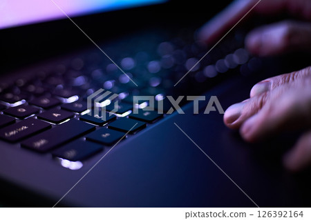 Male hands are typing on a laptop keyboard. Male hands are typing on a laptop keyboard. 126392164