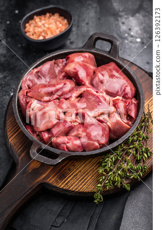 Vibrant raw chicken liver, perfect giblets for those seeking a protein-rich addition to their meals.black background. top view Vibrant raw chicken liver, perfect giblets for those seeking a protein-rich addition to their meals.black background. top view 126392173