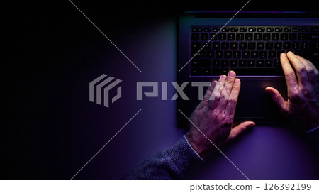 Male hands are typing on a laptop keyboard. Male hands are typing on a laptop keyboard. 126392199