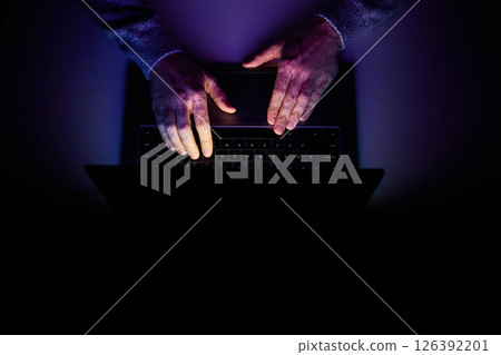 Male hands are typing on a laptop keyboard. 126392201