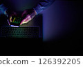 Male hands are using calculator on mobile phone and laptop keyboard. 126392205