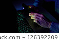 Male hands are using calculator on mobile phone and laptop keyboard. 126392209
