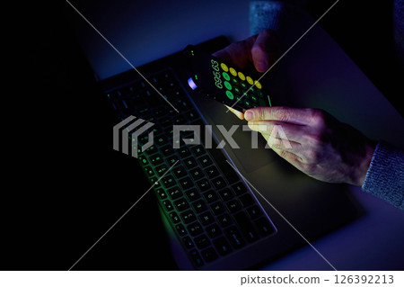 Male hands are using calculator on mobile phone and laptop keyboard. Male hands are using calculator on mobile phone and laptop keyboard. 126392213