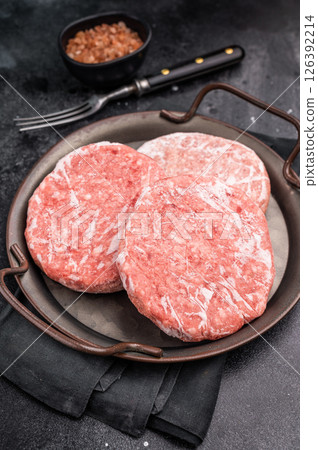 Frozen Meat cutlet, mincemeat of pork and beef for burgers. black background. top view 126392214