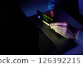 Male hands are using calculator on mobile phone and laptop keyboard. 126392215