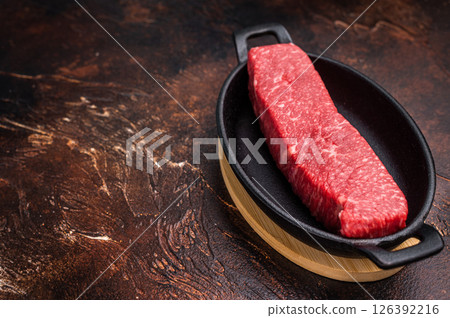 Tender wagyu loin, displaying its luscious fat distribution and deep color. An exquisite ingredient for creating unforgettable meals at home. brown background. top view Tender wagyu loin, displaying its luscious fat distribution and deep color. An exquisite ingredient for creating unforgettable meals at home. brown background. top view 126392216