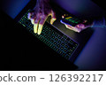 Male hands are using calculator on mobile phone and laptop keyboard. 126392217