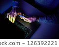 Male hands are using calculator on mobile phone and laptop keyboard. 126392221