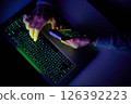 Male hands are using calculator on mobile phone and laptop keyboard. 126392223