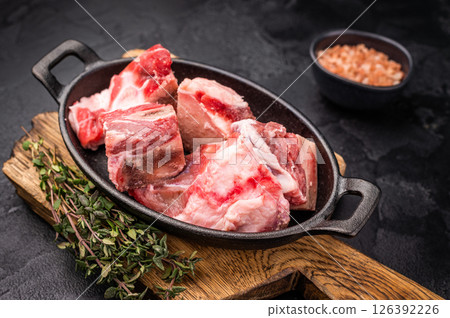 Raw chopped lamb meat with bones, uncooked mutton ready for cooking. black background. top view Raw chopped lamb meat with bones, uncooked mutton ready for cooking. black background. top view 126392226