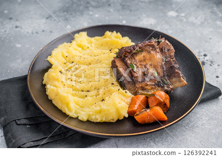 Slow cooked Beef short ribs, perfectly cooked and glazed with a rich barbecue sauce. grey background. top view 126392241