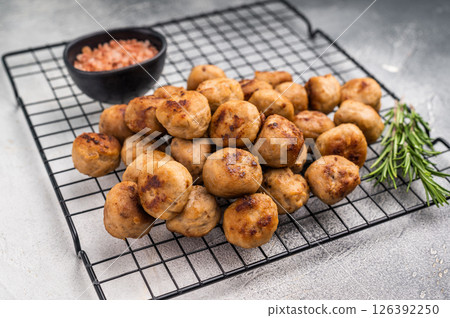 Fried Meatballs from beef and pork minced meat garnished with fresh herbs. grey background. top view Fried Meatballs from beef and pork minced meat garnished with fresh herbs. grey background. top view 126392250