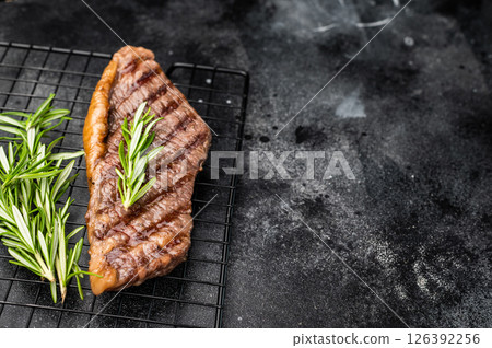 Grilled Brazilian picanha, rump cap beef steak. black background. top view Grilled Brazilian picanha, rump cap beef steak. black background. top view 126392256
