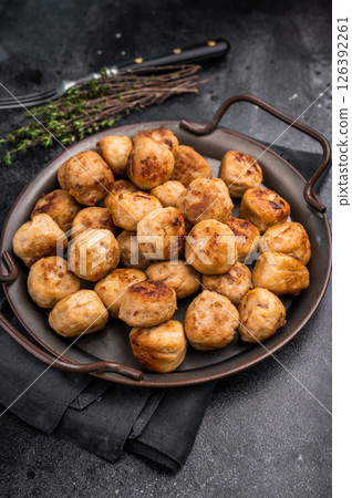 Flavorful ground meat balls, meatballs expertly crafted from a blend of spices and herbs. black background. top view Flavorful ground meat balls, meatballs expertly crafted from a blend of spices and herbs. black background. top view 126392261