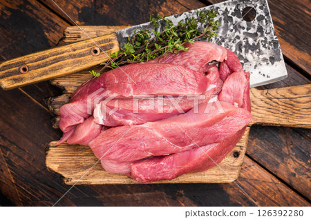 Duck breast fillet, raw sliced poultry meat on butcher board. wooden background. top view Duck breast fillet, raw sliced poultry meat on butcher board. wooden background. top view 126392280