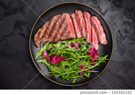 Succulent Denver cut, showcasing a perfect sear and rich color after grilling. black background. top view Succulent Denver cut, showcasing a perfect sear and rich color after grilling. black background. top view 126392282