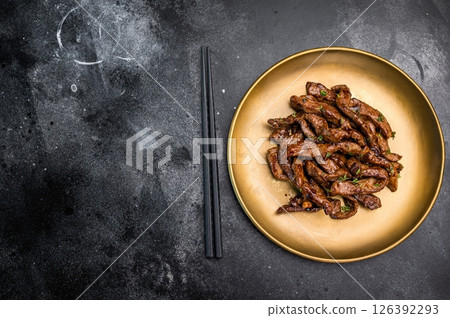 Asian food Teriyaki beef meat on a plate on black background. top view 126392293