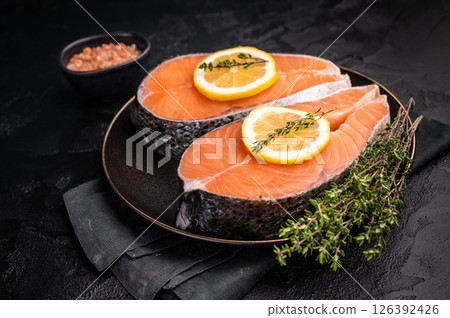 High-quality salmon portion, ready to be transformed into a gourmet dish. A versatile ingredient for both traditional and modern recipes. black background. top view 126392426
