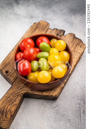 Fresh small red, green and yellow cherry tomatoes assortment, mini organic cocktail tomate mix. white background. top view 126392448