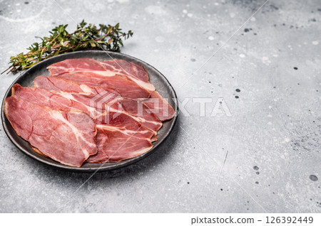 Slices of prsut, Balkan pork meat ham. grey background. top view 126392449