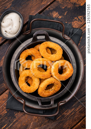 Crispy Fried squid rings, calamari fastfood snack. wooden background. top view Crispy Fried squid rings, calamari fastfood snack. wooden background. top view 126392565