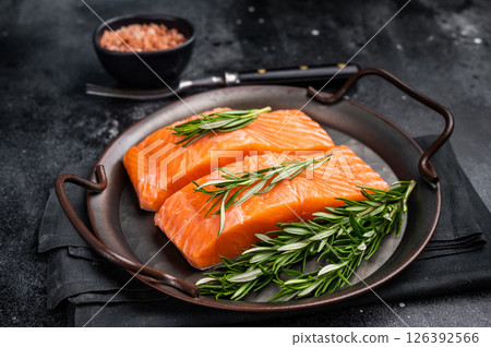 Raw Salmon fillet steak with rosemary ready for cooking. black background. top view 126392566