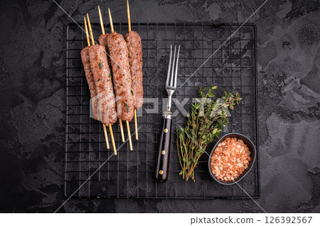Grilled Cevapcici skewers, Cevapi sausages from mince beef and pork meat. black background. top view Grilled Cevapcici skewers, Cevapi sausages from mince beef and pork meat. black background. top view 126392567