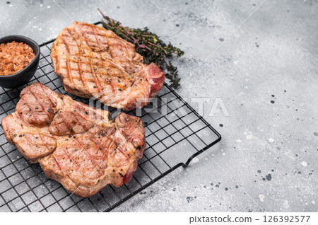 Grilled pork neck steaks, fillet meat. grey background. top view Grilled pork neck steaks, fillet meat. grey background. top view 126392577