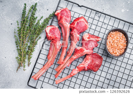 Raw lamb meat chops, fresh mutton cutlets. grey background. top view Raw lamb meat chops, fresh mutton cutlets. grey background. top view 126392626