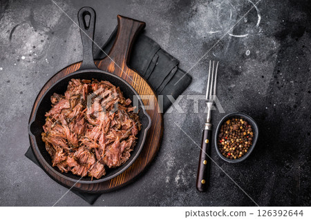 Traditional barbecue pulled beef, Slow cooked meat cooked in a smoker. black background. top view 126392644