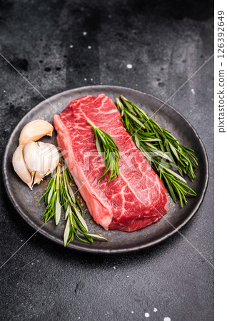 Australian Oyster Top blade steak, Fresh Beef shoulder meat on plate. black background. top view Australian Oyster Top blade steak, Fresh Beef shoulder meat on plate. black background. top view 126392649