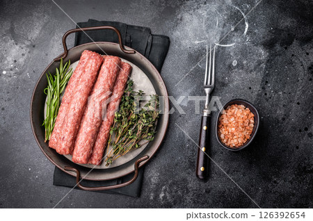 Fresh minced beef and lamb kebabs with fresh spices, arabic kofta kofte kebab. black background. top view Fresh minced beef and lamb kebabs with fresh spices, arabic kofta kofte kebab. black background. top view 126392654