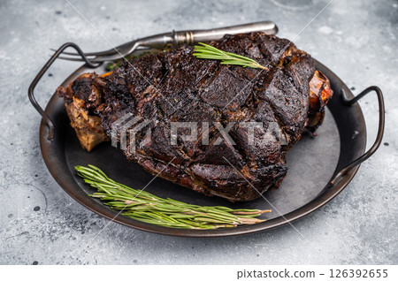 Slow cooked venison roast leg. Braised game meat of deer with bone. grey background. top view 126392655