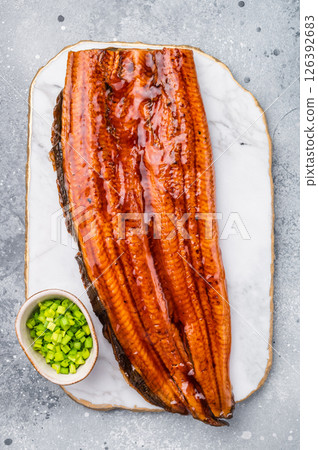 Unagi eel, Japanese grilled fish fillet of eel with sauce. grey background. top view 126392683